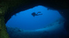 Scuba diver at mouth of underwater cave