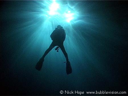 Backlit diver in silhouette
