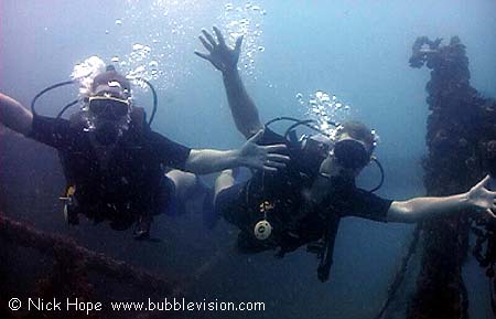 scuba divers on the King Cruiser wreck